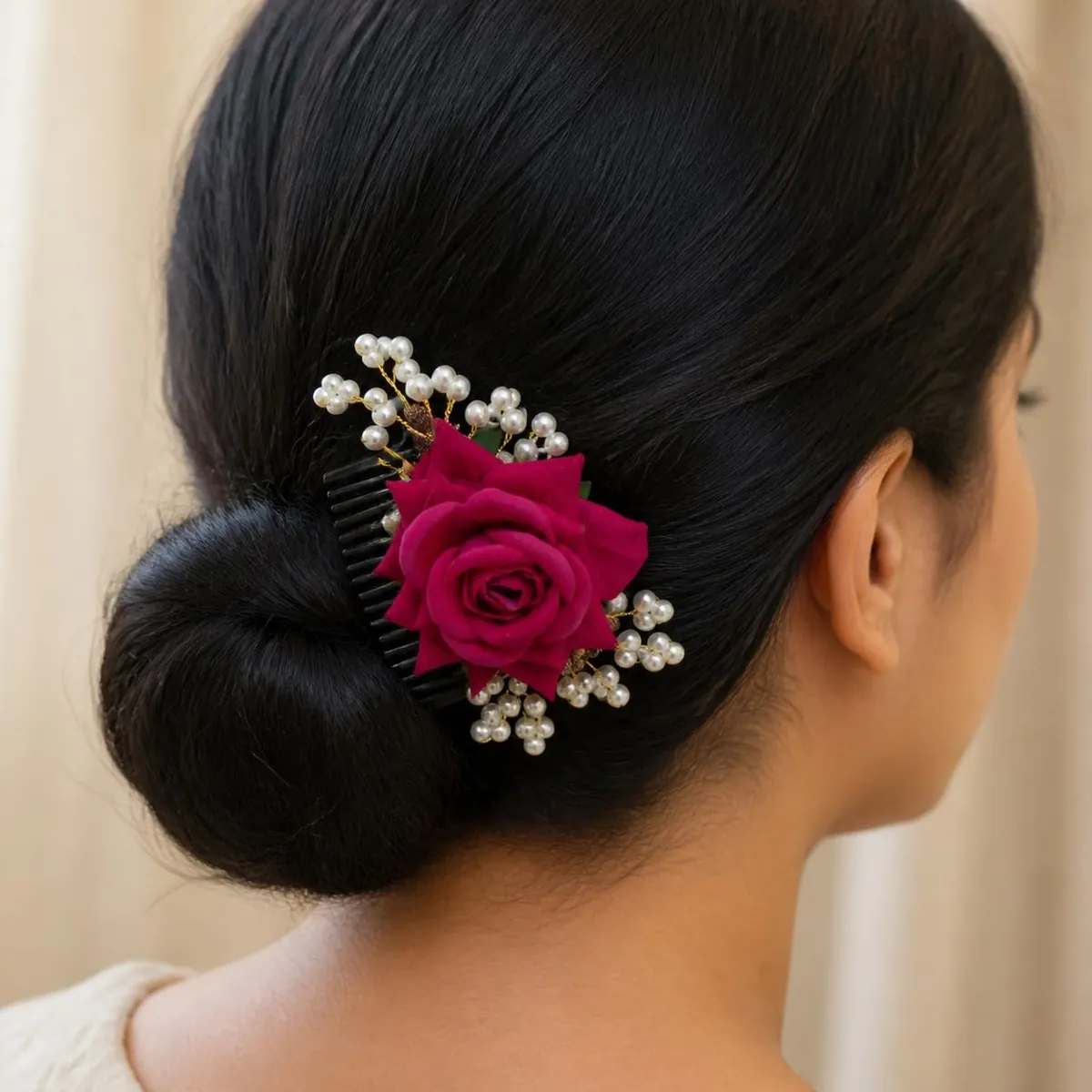 A rani pink rose juda comb with pearl sprays set in a bun