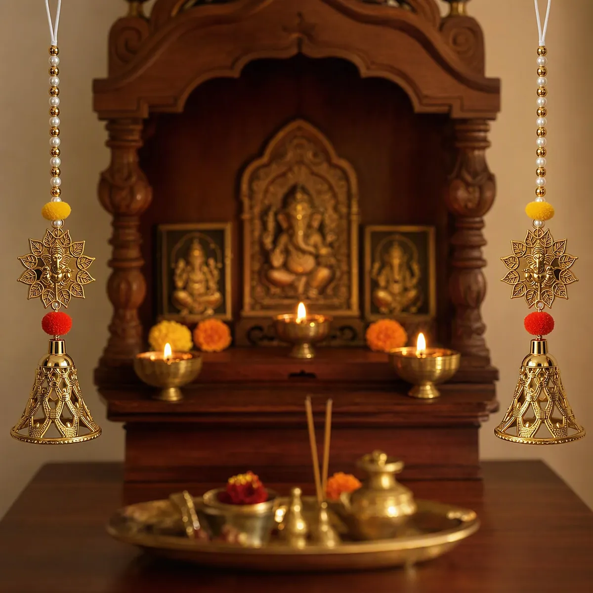A home mandir with a Ganesh idol, lit diyas and latkans on either side
