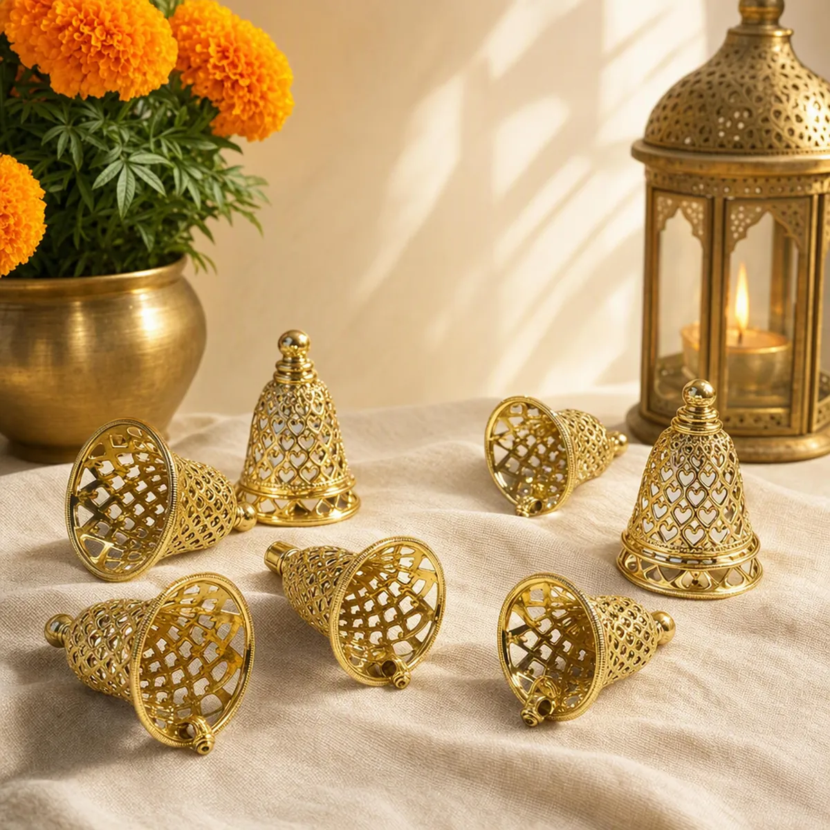 Golden filigree jingle bells resting among marigolds and brass lamps