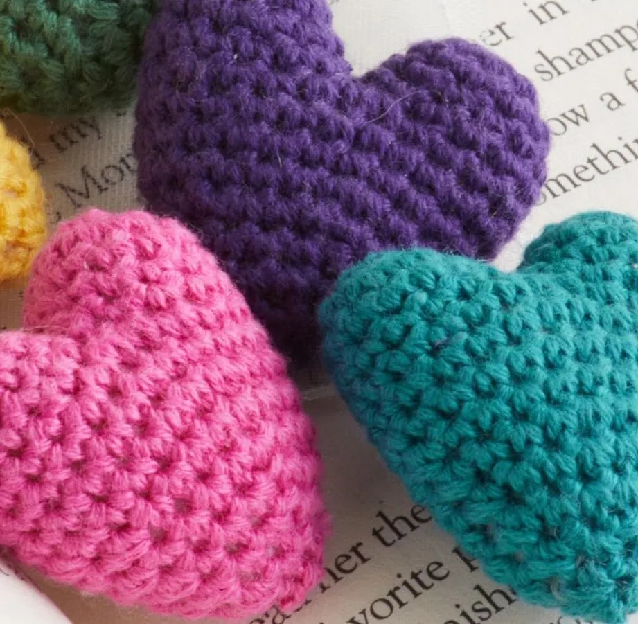 Close up of the stitches on two crochet hearts
